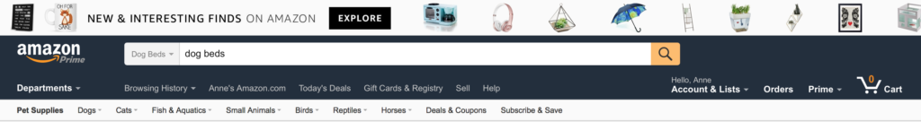Amazon's global header as of March 19, 2017. Below a row of images representing products, the brand channel is a very dark blue with white text for the global navigation. The sub navigation directly below is black on white text. Very few elements contain color. 